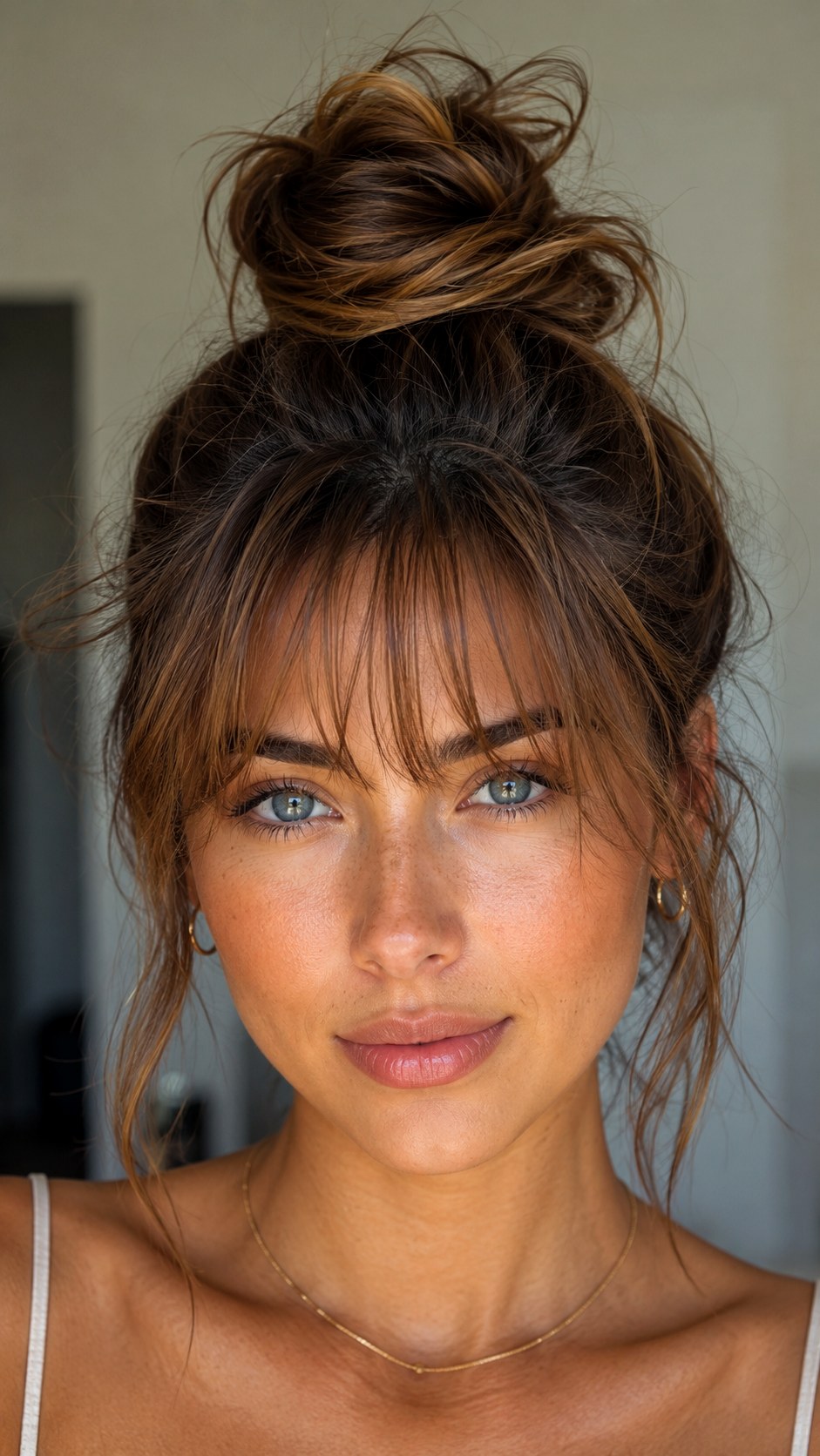 Wispy Bangs Paired With Messy Bun - 25 y2k bun hairstyle ideas